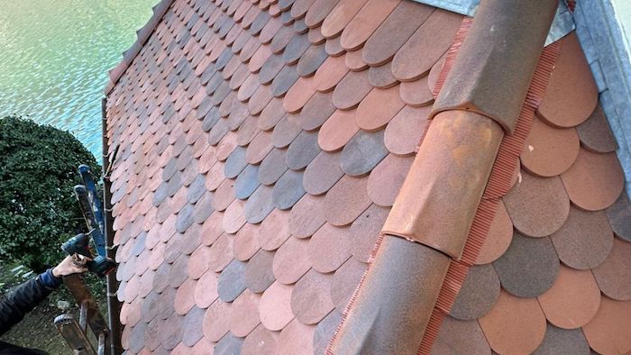 Rénovation d&rsquo;une couverture en tuiles écailles à Annecy : réfection d&rsquo;une toiture d&rsquo;entrée sur une maison du bord du lac